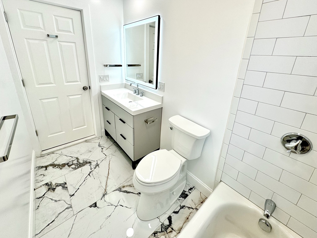 190 Hillside Street, Unit 1 Boston, MA 02120 - Photo 3 of 27 a bathroom with a sink toilet and shower