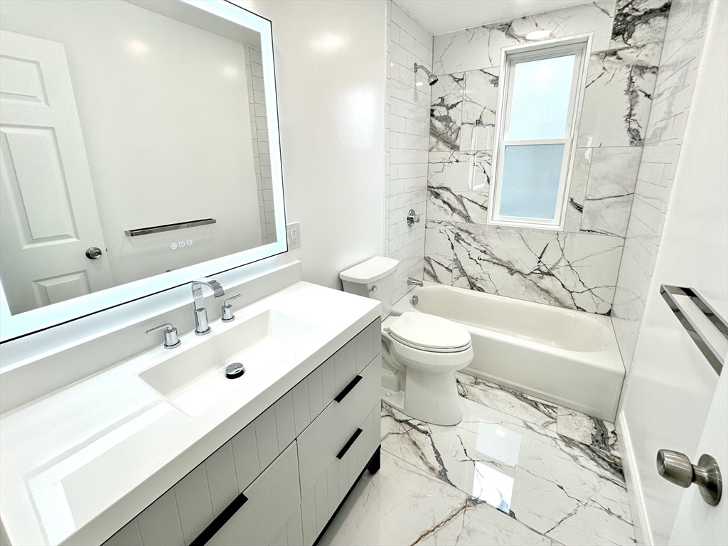 190 Hillside Street, Unit 1 Boston, MA 02120 - Photo 4 of 27 a bathroom with a sink a toilet and shower