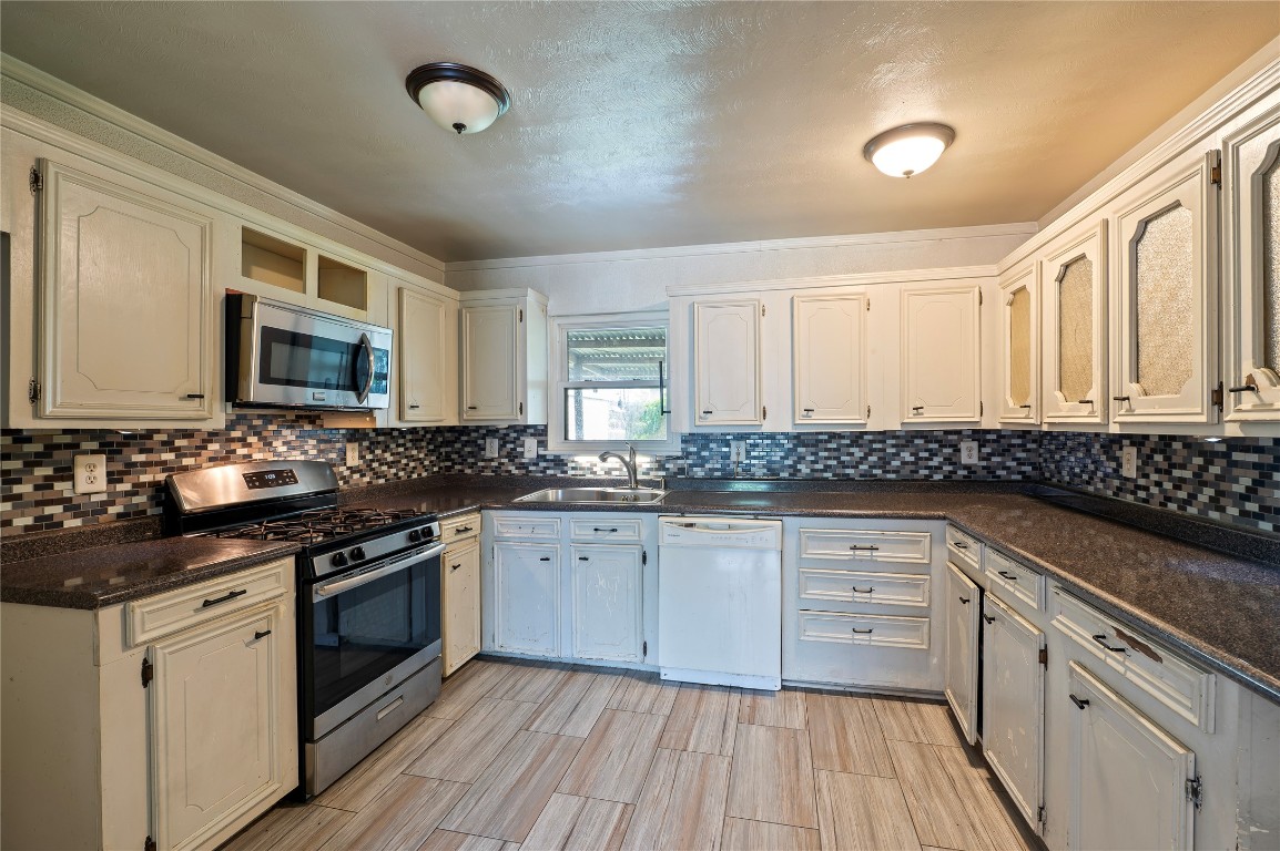 2308 Grape Lane Pasadena, TX 77502 - Photo 12 of 19 a kitchen with granite countertop cabinets stainless steel appliances and a sink