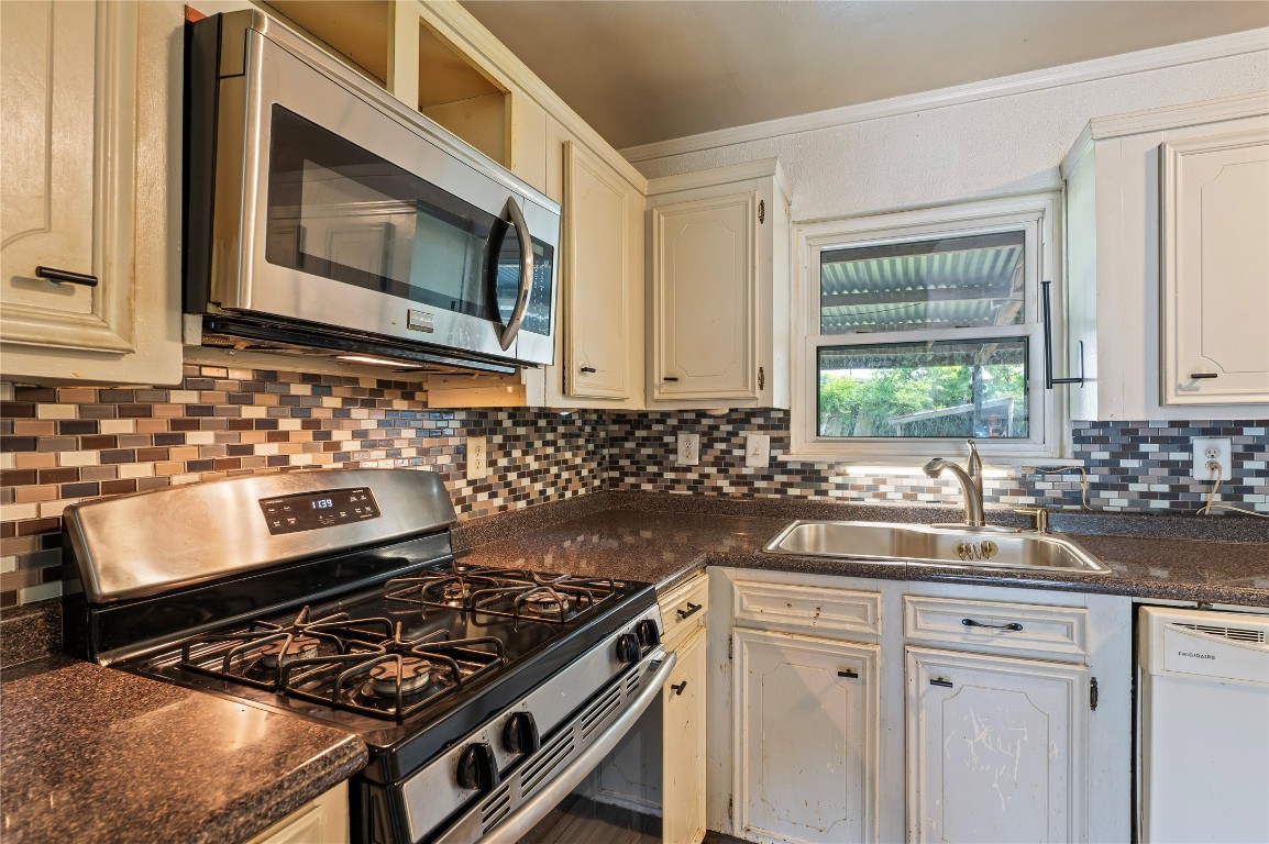 2308 Grape Lane Pasadena, TX 77502 - Photo 13 of 19 a kitchen with a stove a sink and a microwave