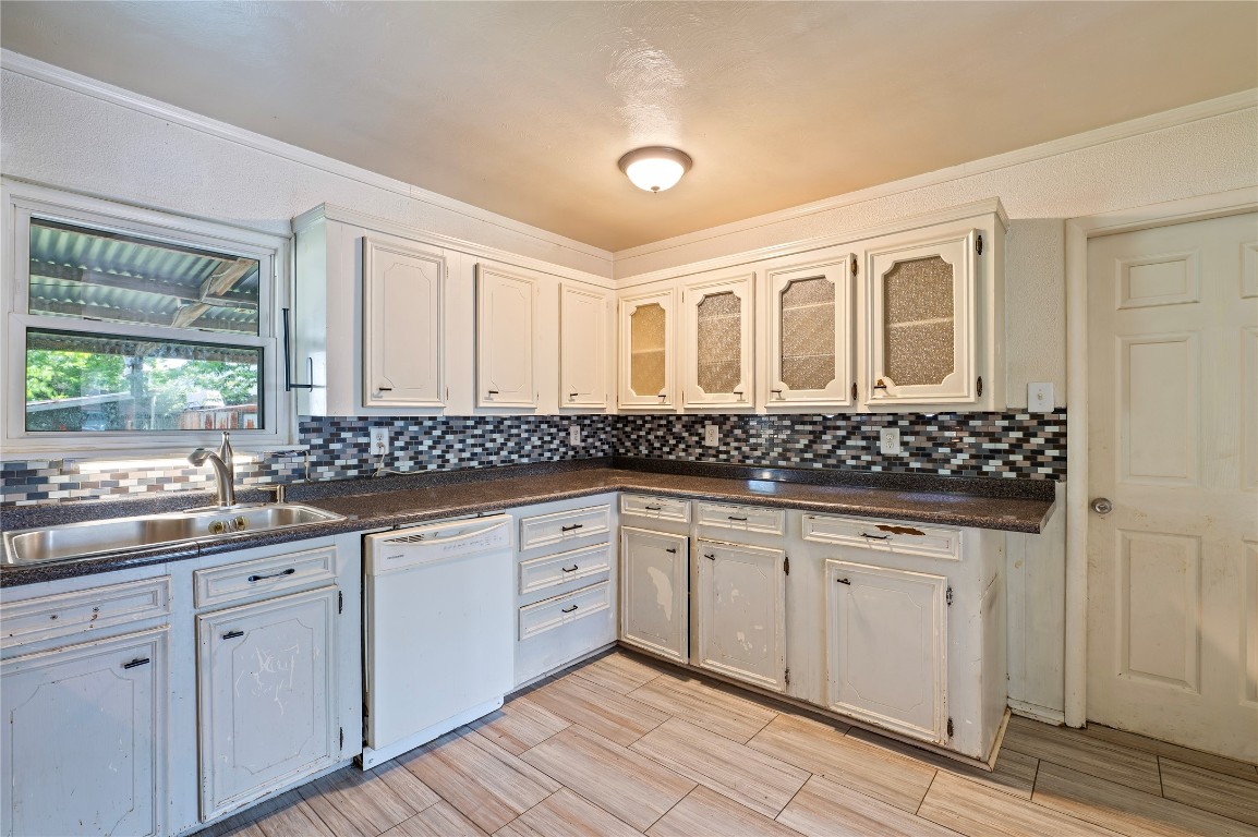 2308 Grape Lane Pasadena, TX 77502 - Photo 14 of 19 a kitchen with white cabinets sink and window
