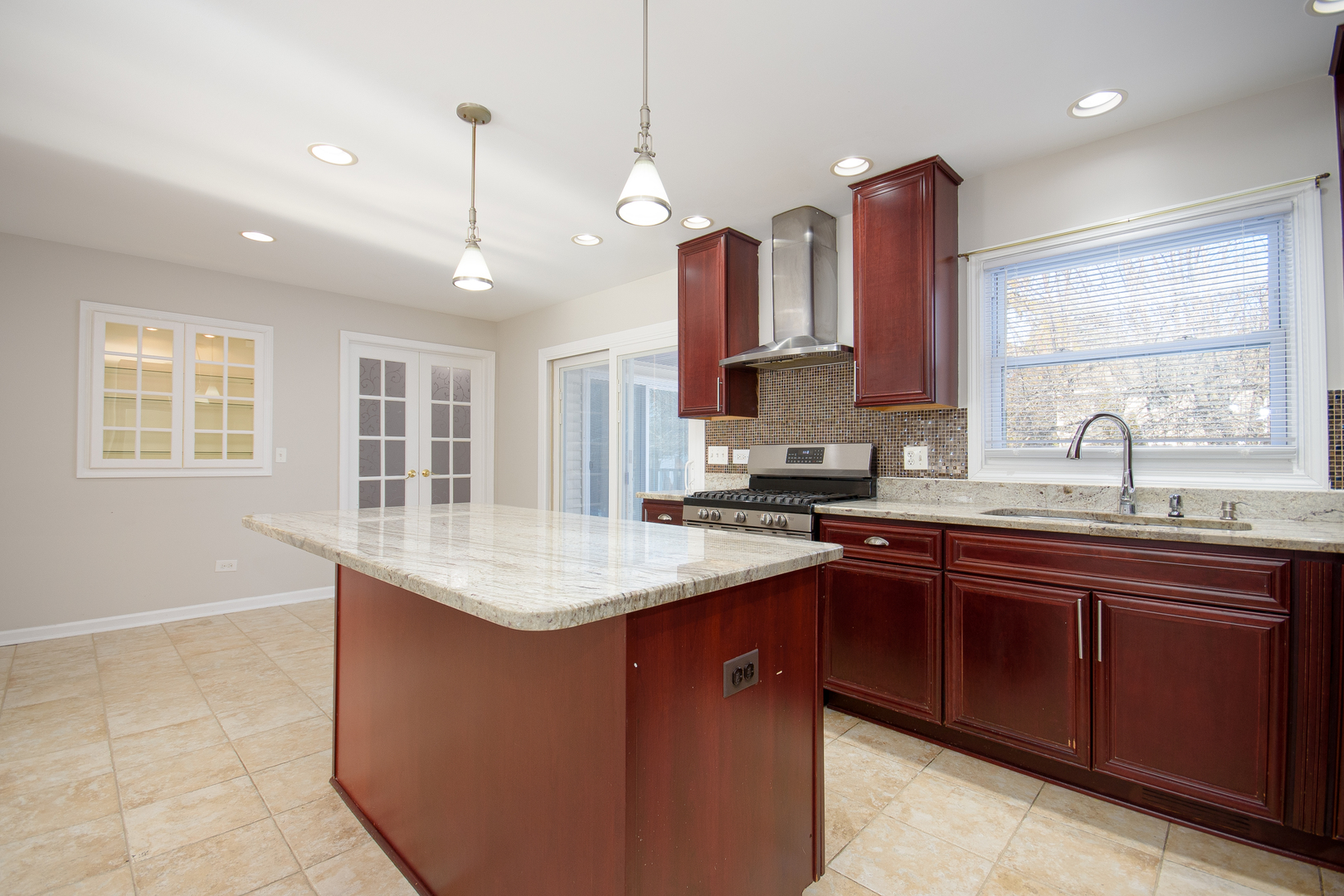 317 Arapahoe Trail Carol Stream, IL 60188 - Photo 4 of 16 a kitchen with stainless steel appliances granite countertop a sink a stove and a wooden cabinets