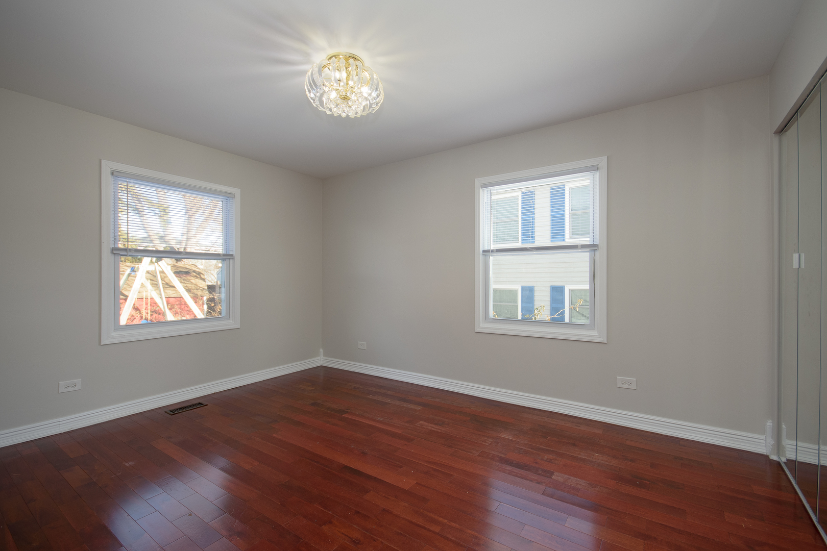 317 Arapahoe Trail Carol Stream, IL 60188 - Photo 7 of 16 a view of an empty room with a window and wooden floor