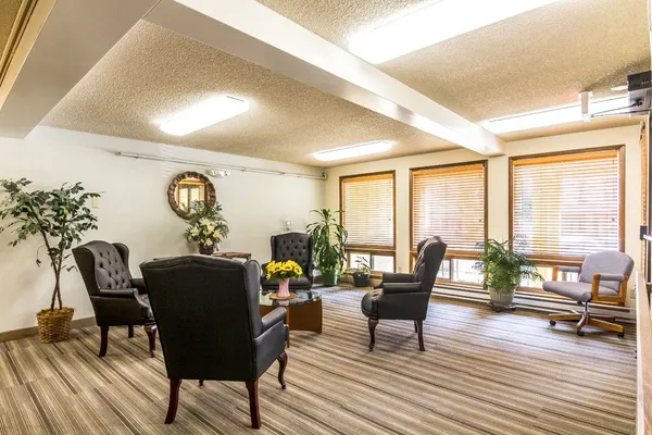 a living room with furniture and floor to ceiling window