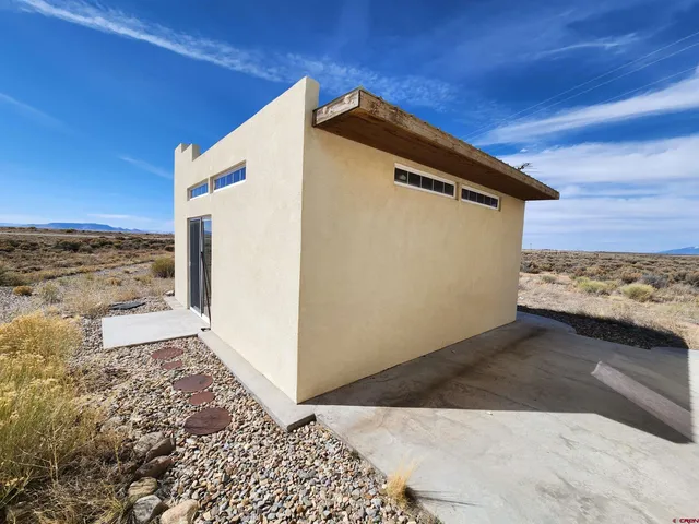 a view of a wooden floor and a building in the background