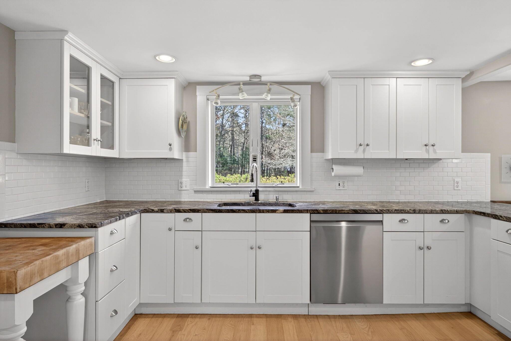 69 County Road Bourne, MA 02532 - Photo 13 of 54 a kitchen with granite countertop white cabinets and a window
