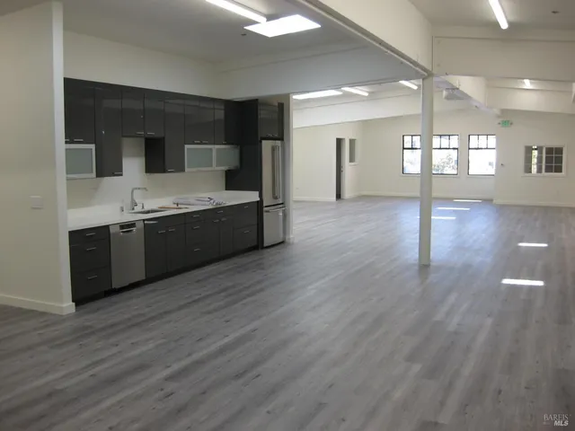 a large kitchen with stainless steel appliances granite countertop a large counter top and sink