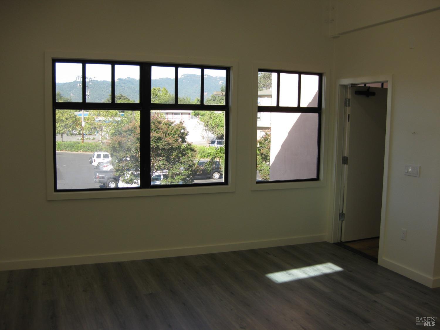 18615 Highway 12 Sonoma, CA 95476 - Photo 9 of 12 an empty room with wooden floor and windows