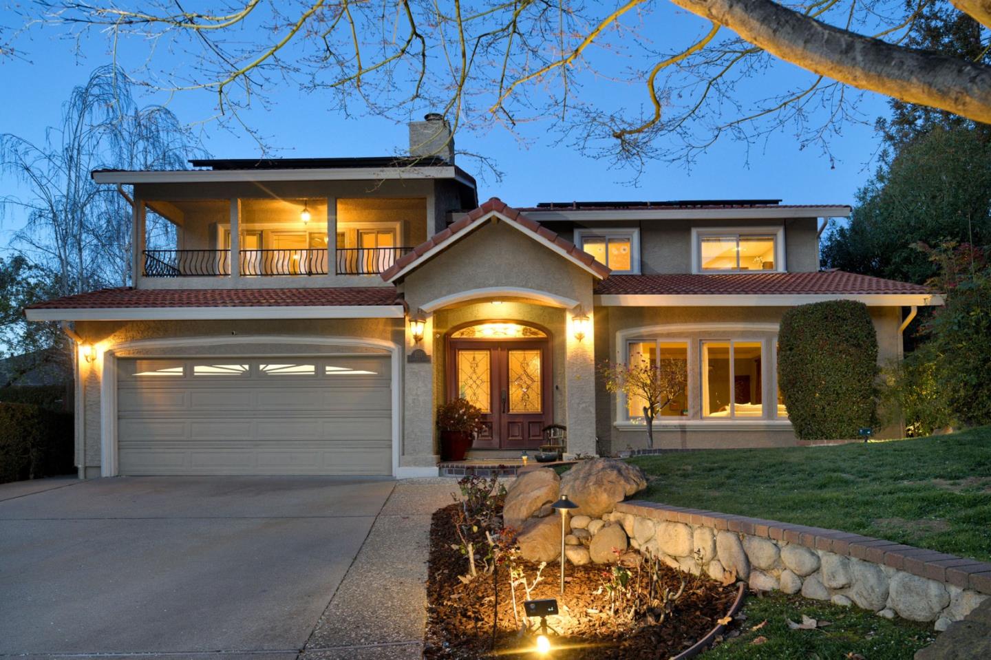 a view of a brick house with a large window and a yard