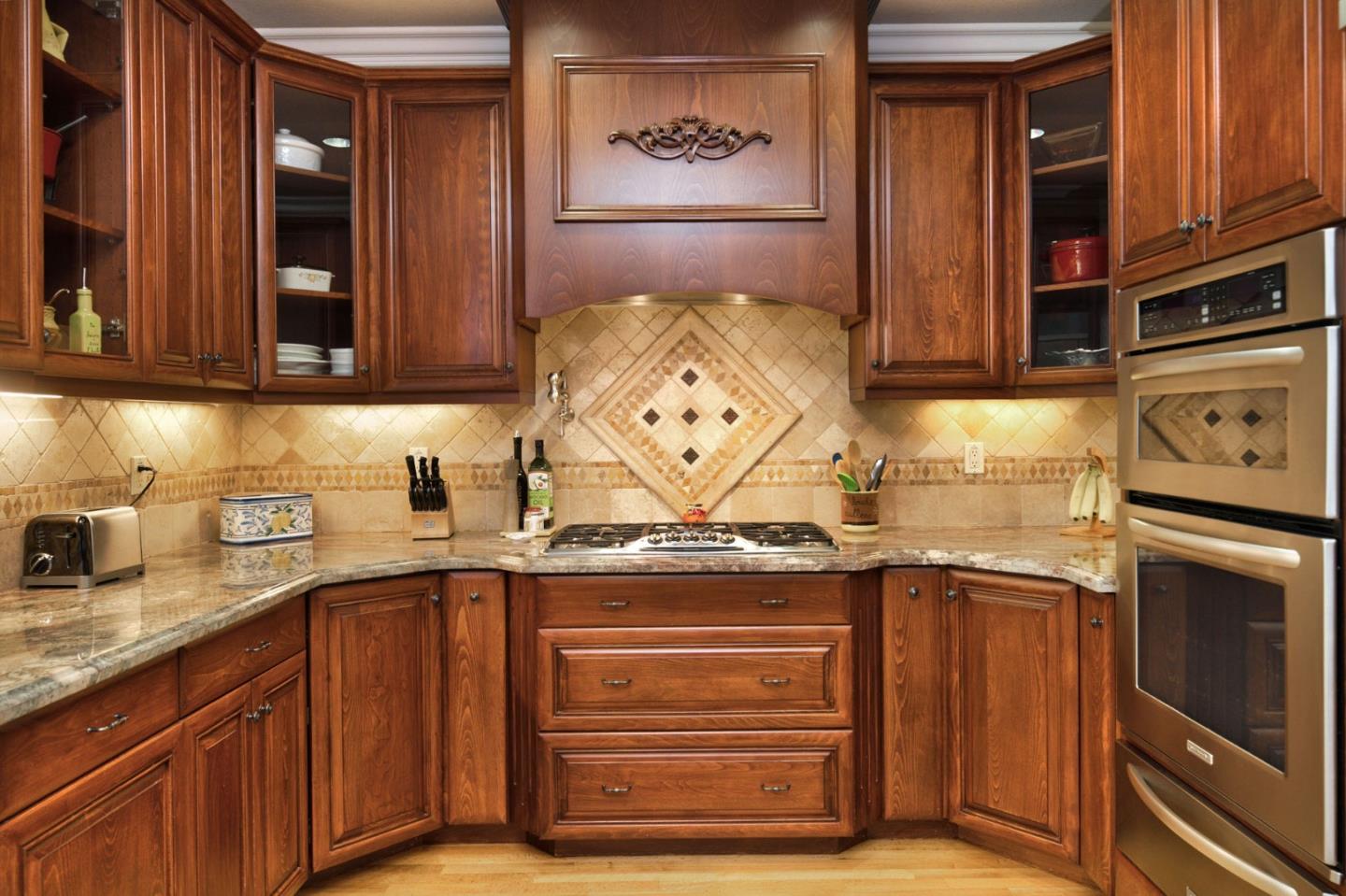 1127 Carnforth Court San Jose, CA 95120 - Photo 14 of 55 a kitchen with stainless steel appliances granite countertop a stove and a microwave