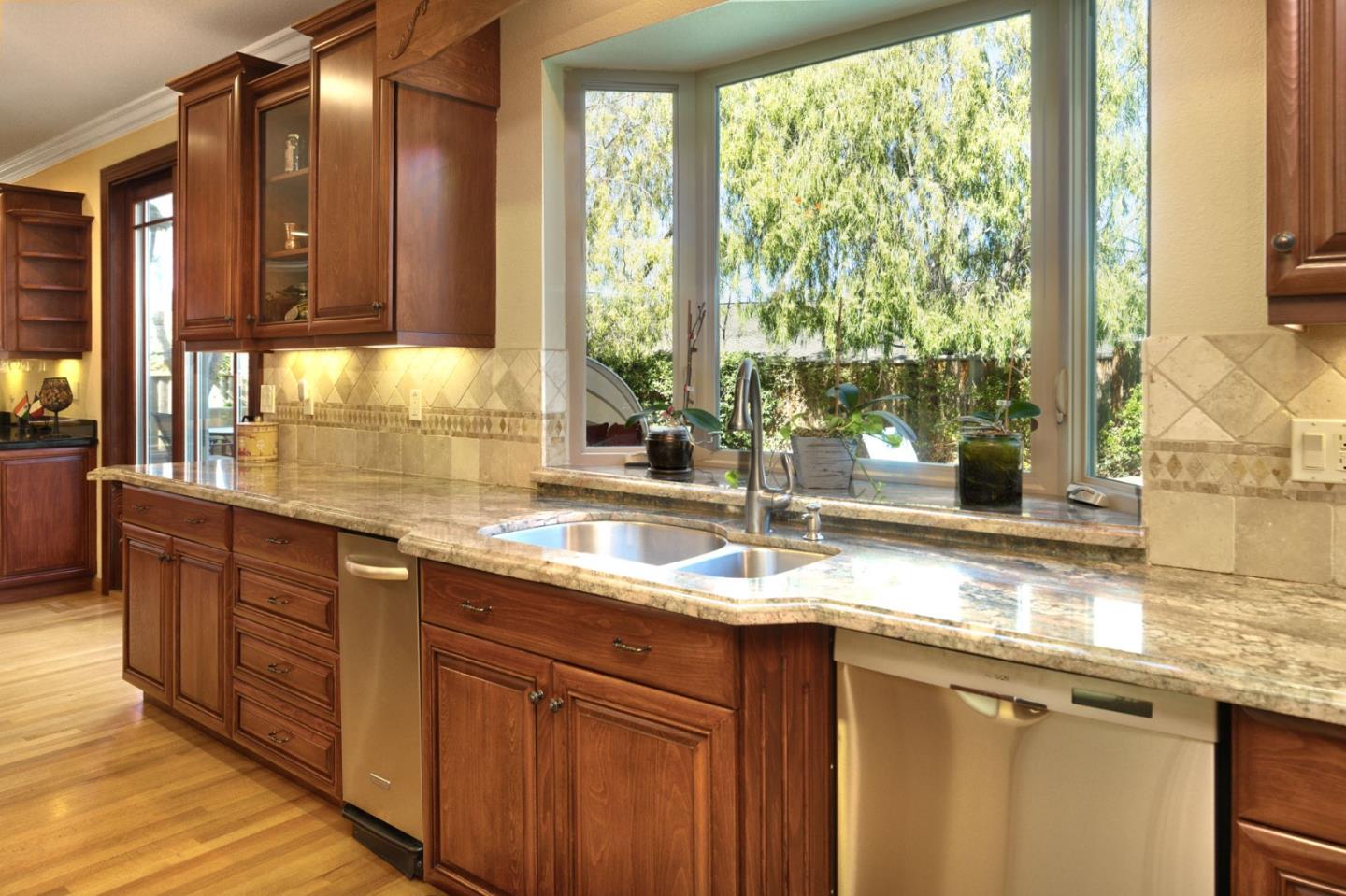 1127 Carnforth Court San Jose, CA 95120 - Photo 15 of 55 a kitchen with stainless steel appliances granite countertop a sink and a large window