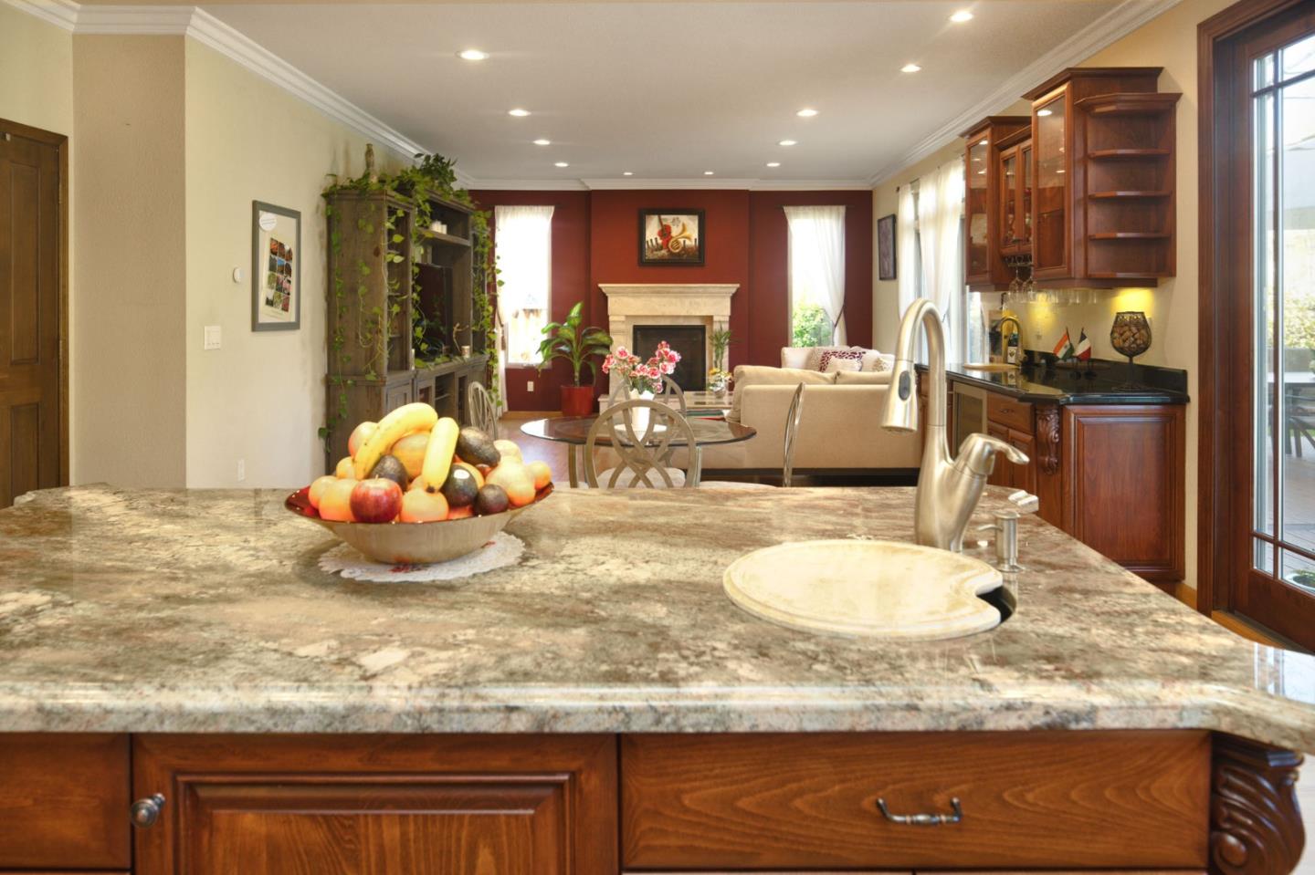1127 Carnforth Court San Jose, CA 95120 - Photo 16 of 55 a kitchen with kitchen island granite countertop wooden cabinets and a refrigerator