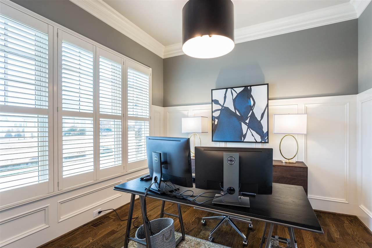 There are 2 offices on the main level. The first office is off the foyer and features custom "barn doors", hardwood floors, and plantation shutters. 1st Floor Office off Foyer