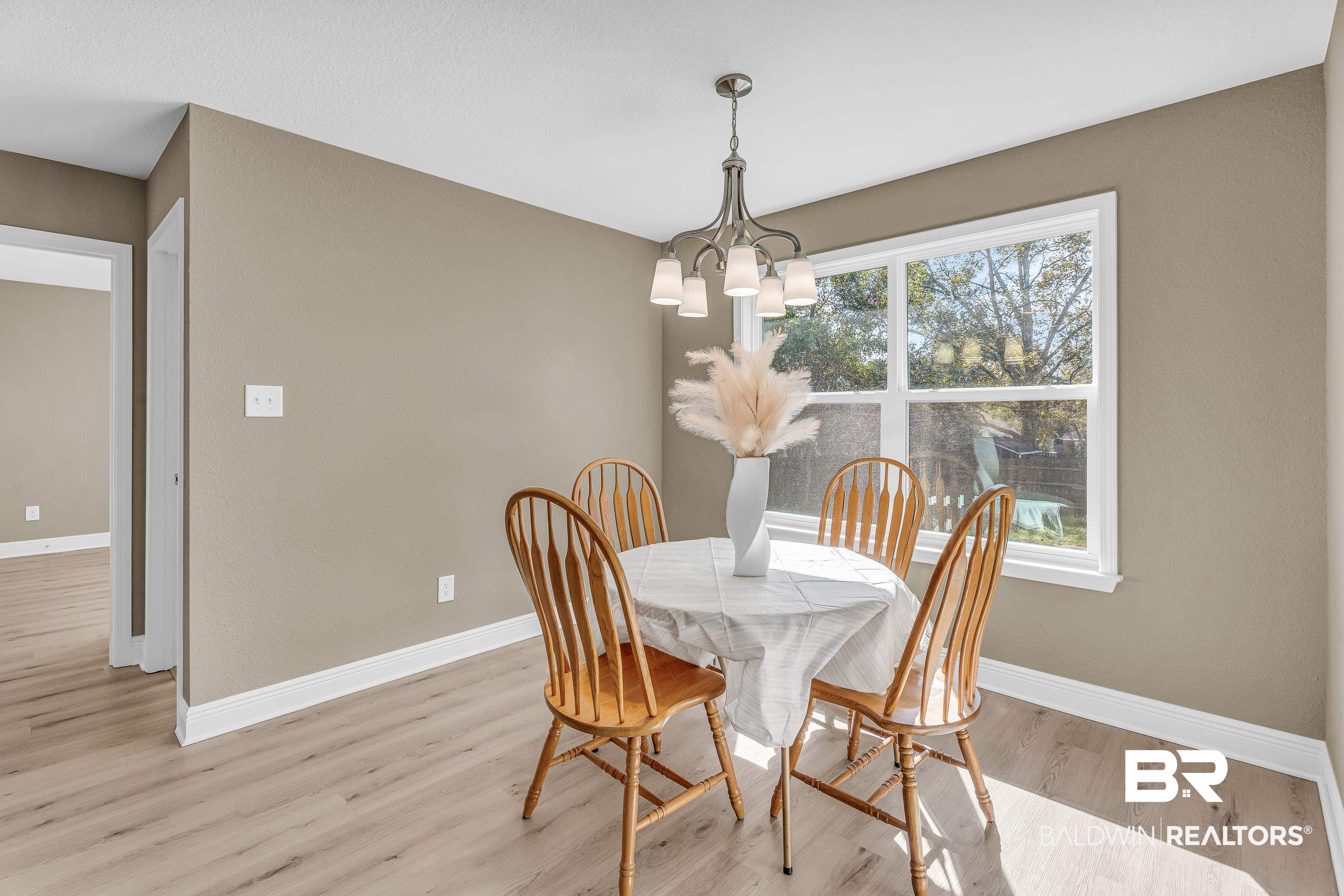9206 Greenleaf Drive Daphne, AL 36527 - Photo 11 of 32 Dining space featuring light wood-type flooring and a chandelier