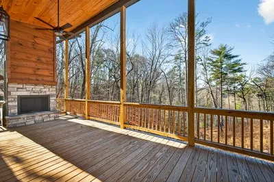 a view of balcony with wooden floor and fence