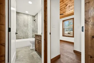 a view of a bathroom with a tub and shower
