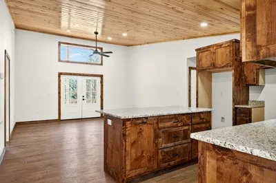 a kitchen with stainless steel appliances granite countertop a sink and dishwasher with wooden floor