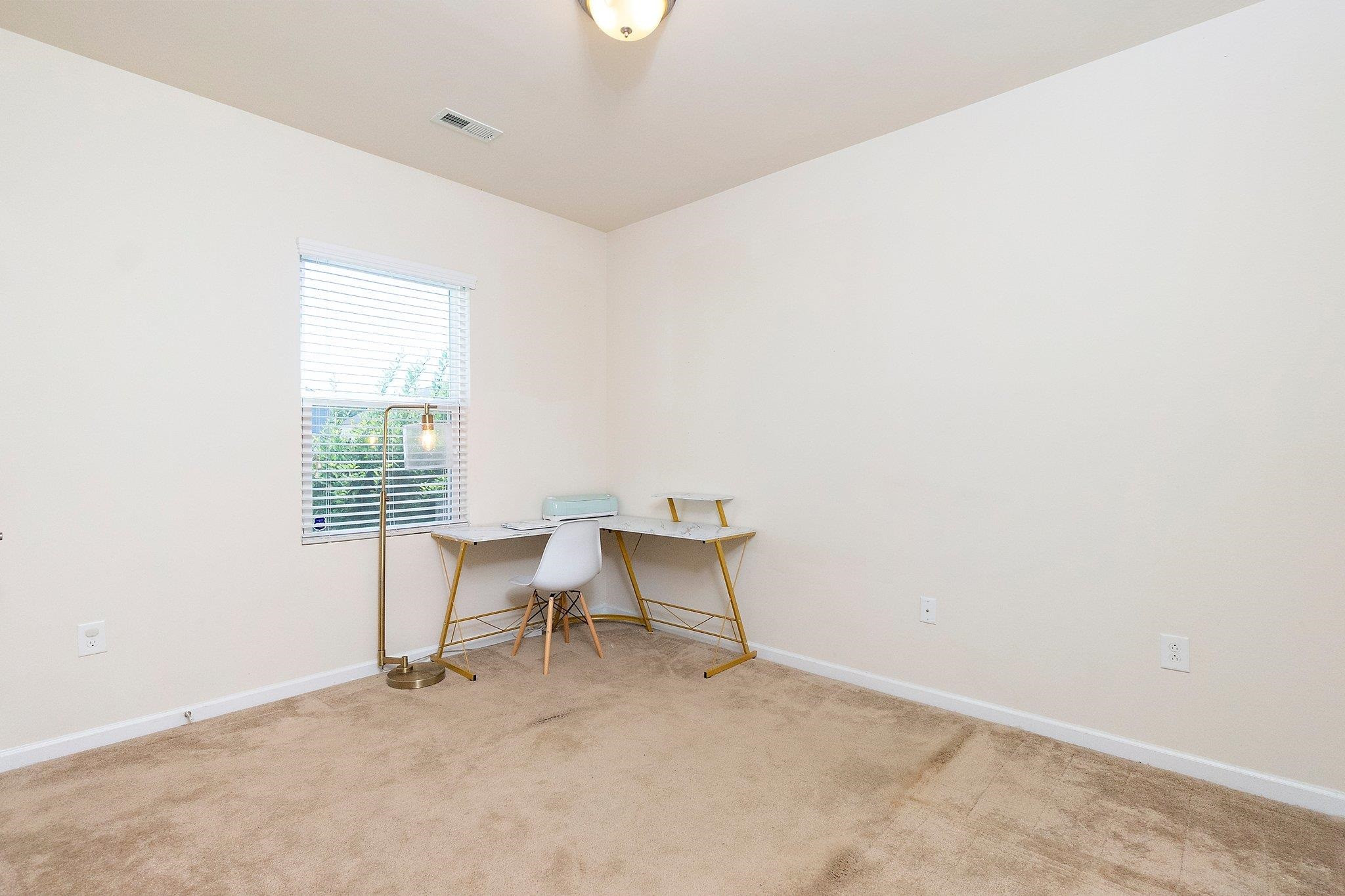 3525 Althorp Drive Raleigh, NC 27616 - Photo 13 of 28 an empty room with chair and window