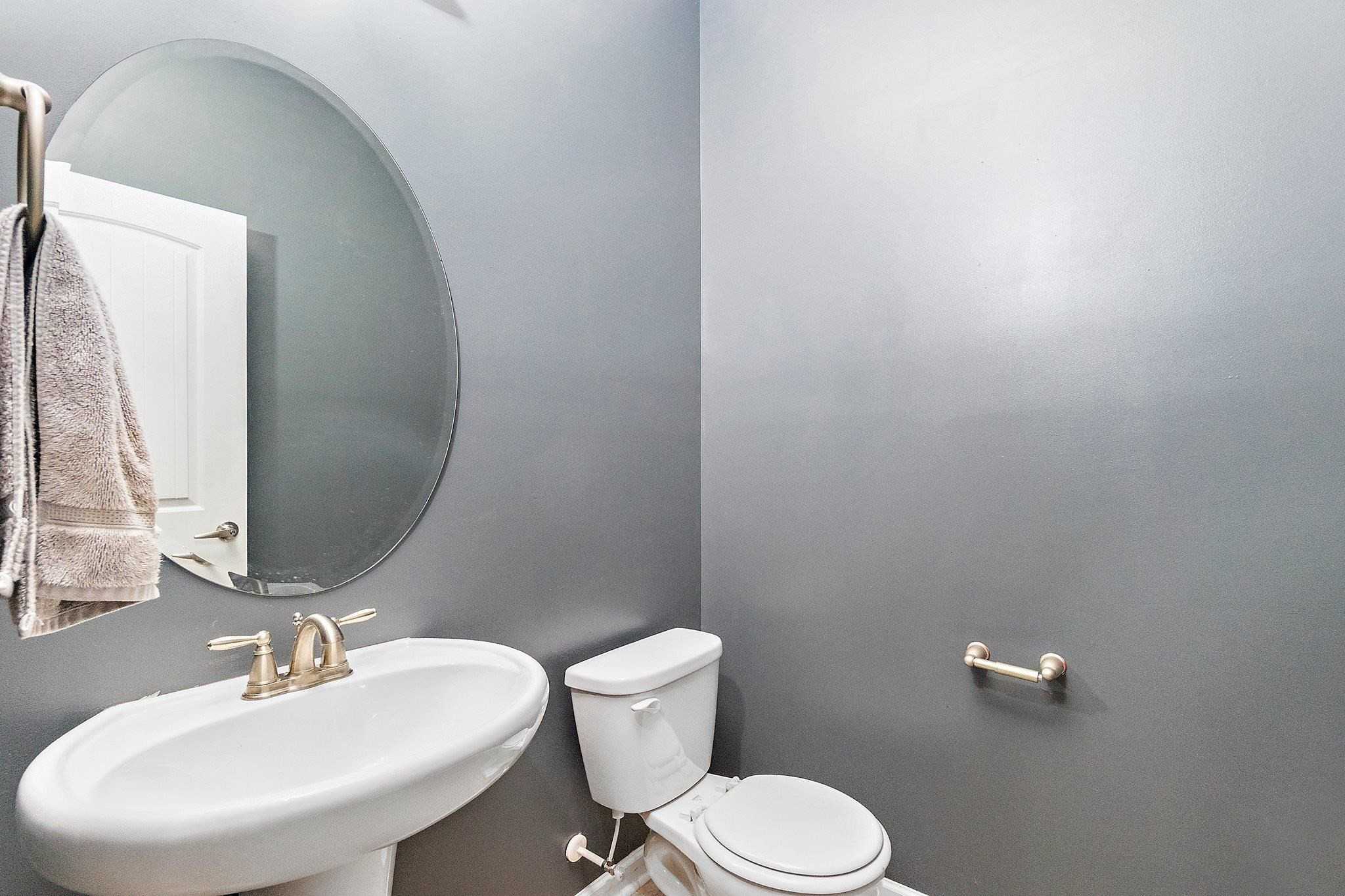 3525 Althorp Drive Raleigh, NC 27616 - Photo 14 of 28 a bathroom with a toilet a sink and mirror