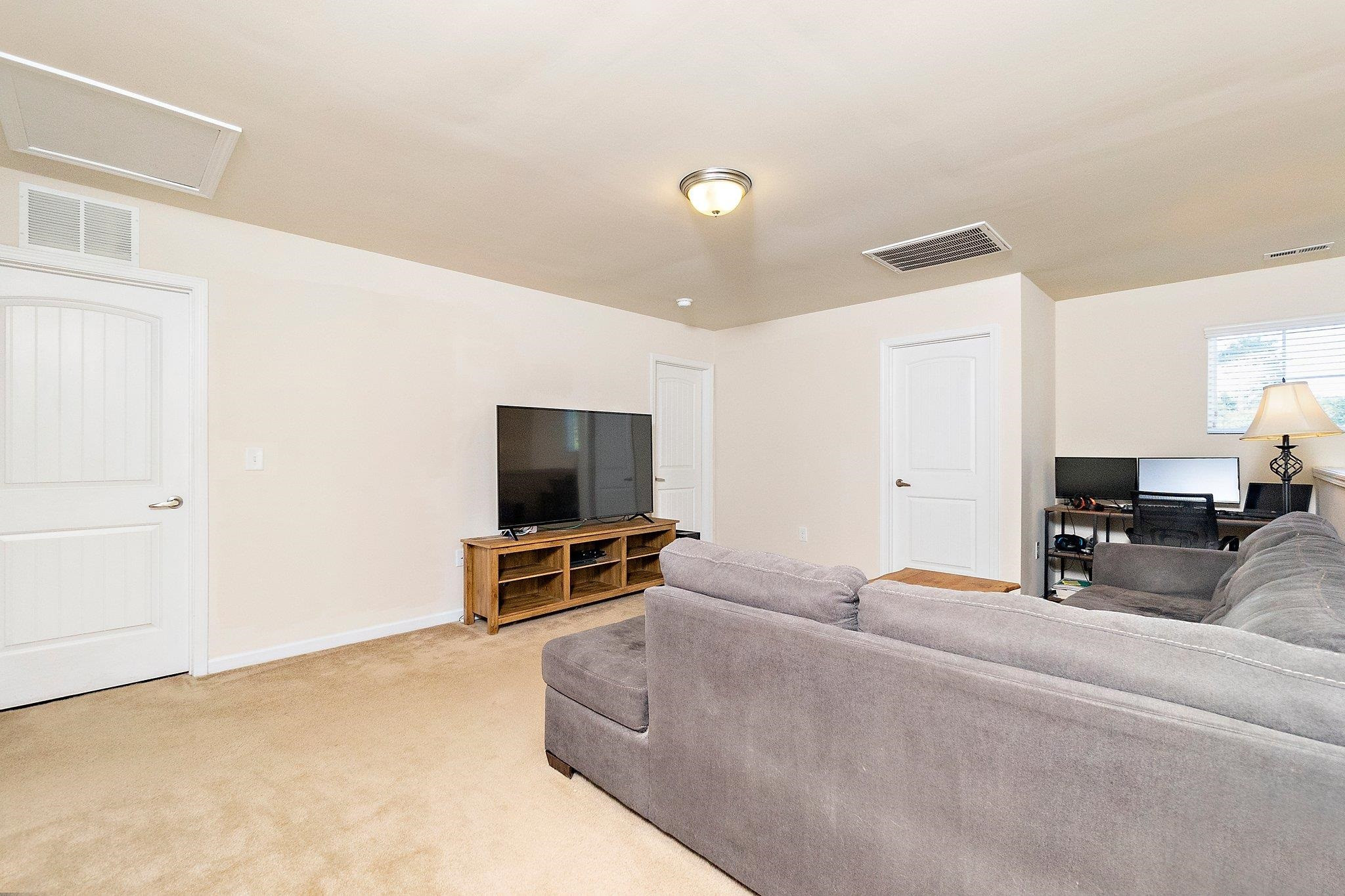 3525 Althorp Drive Raleigh, NC 27616 - Photo 16 of 28 a living room with furniture and a flat screen tv