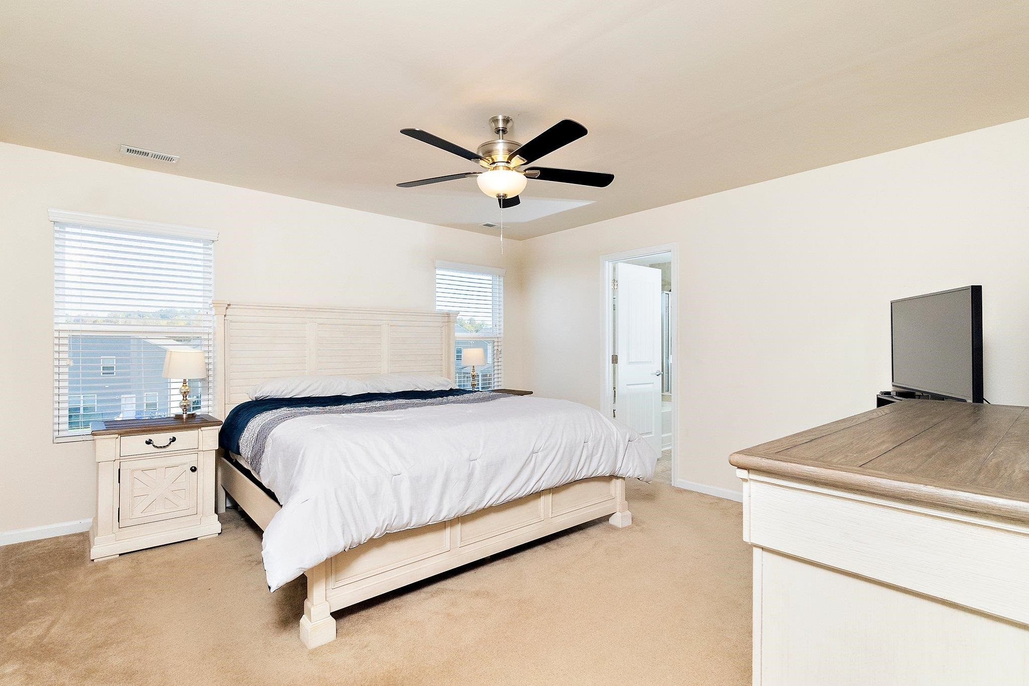 3525 Althorp Drive Raleigh, NC 27616 - Photo 18 of 28 a bedroom with a bed and a ceiling fan