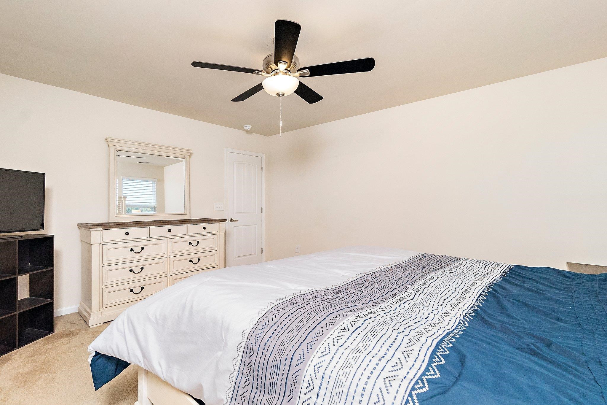 3525 Althorp Drive Raleigh, NC 27616 - Photo 19 of 28 a bedroom with a bed and a dresser