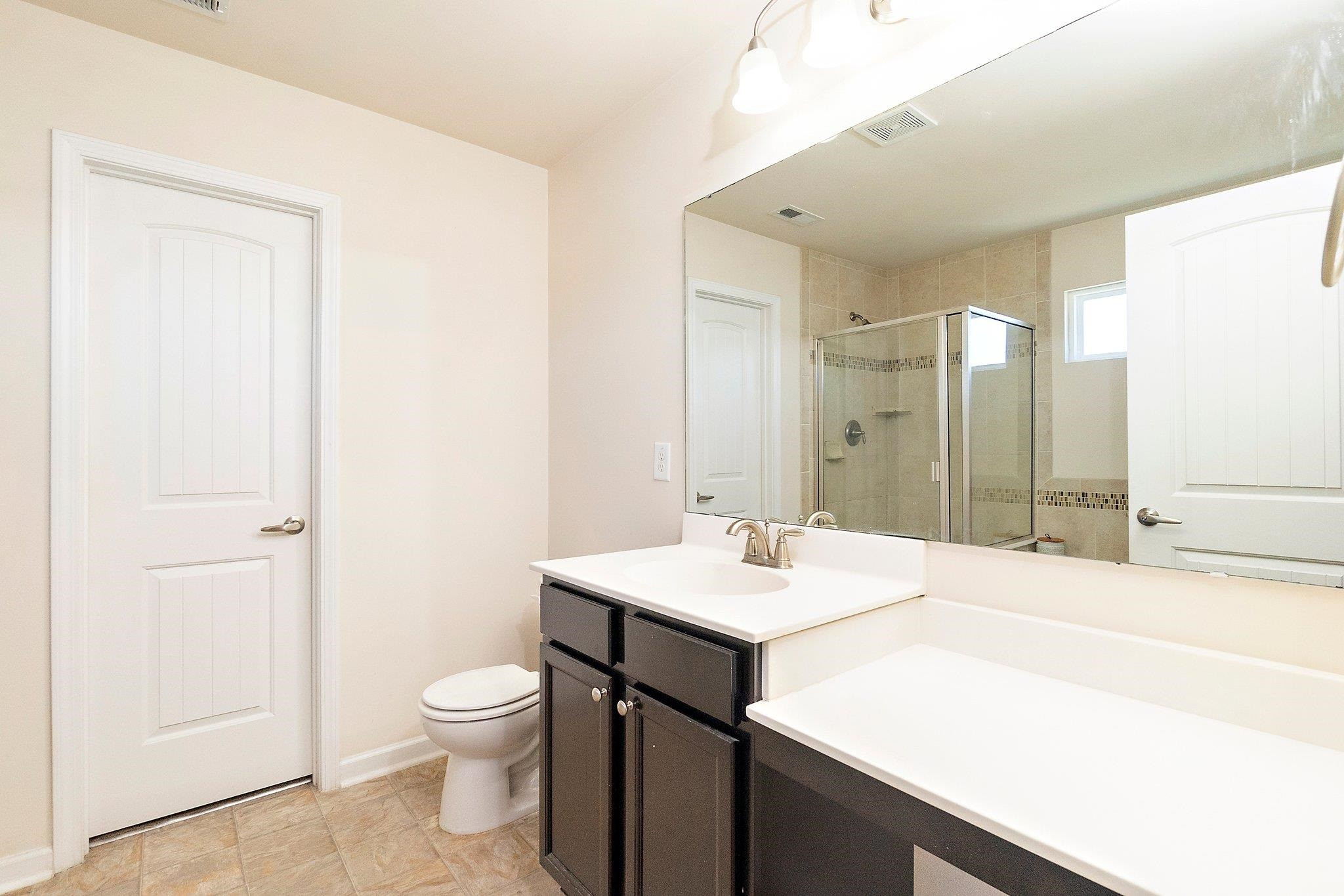 3525 Althorp Drive Raleigh, NC 27616 - Photo 20 of 28 a bathroom with a sink a toilet and shower