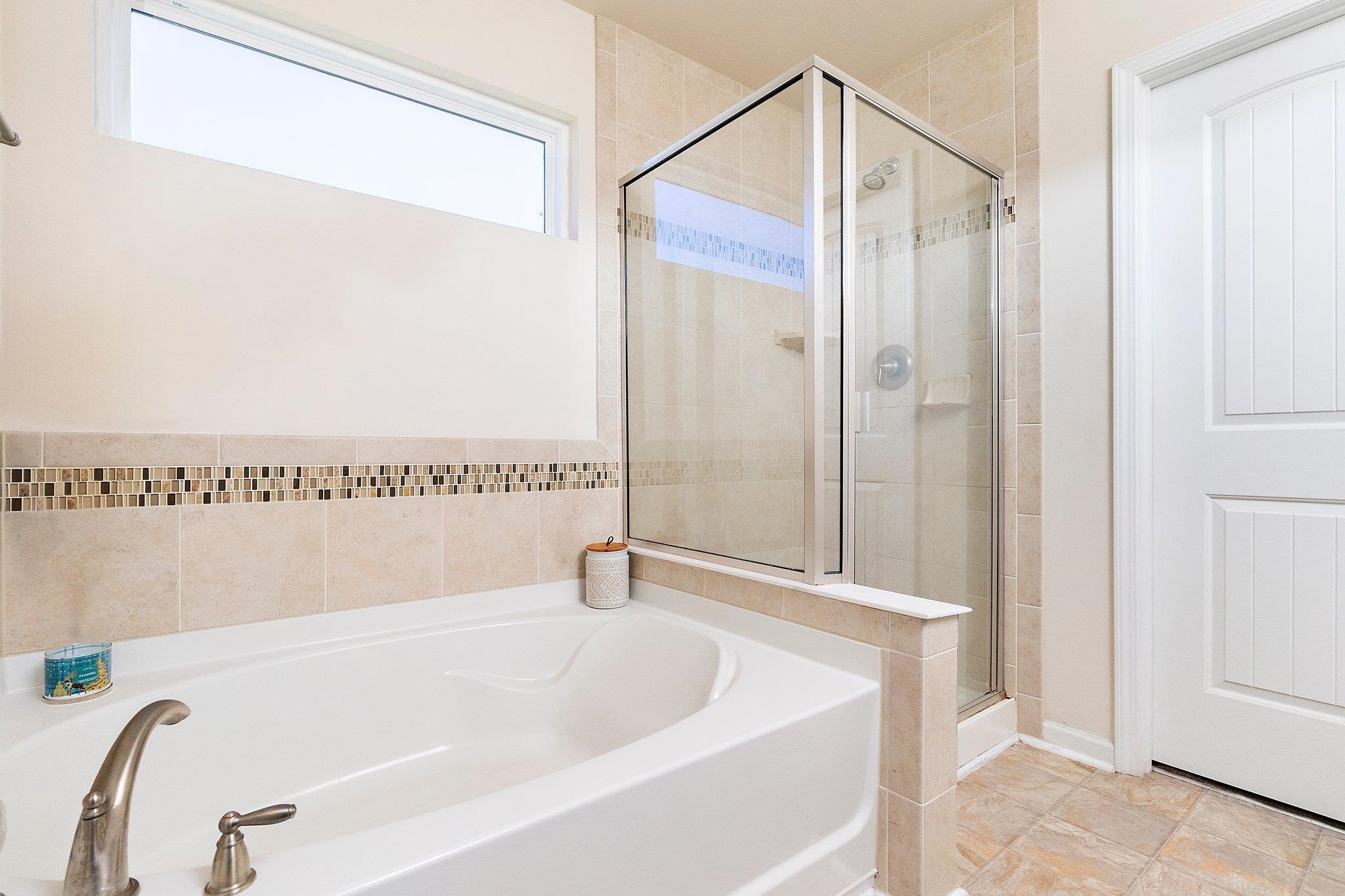3525 Althorp Drive Raleigh, NC 27616 - Photo 21 of 28 a bathroom with a tub and a shower