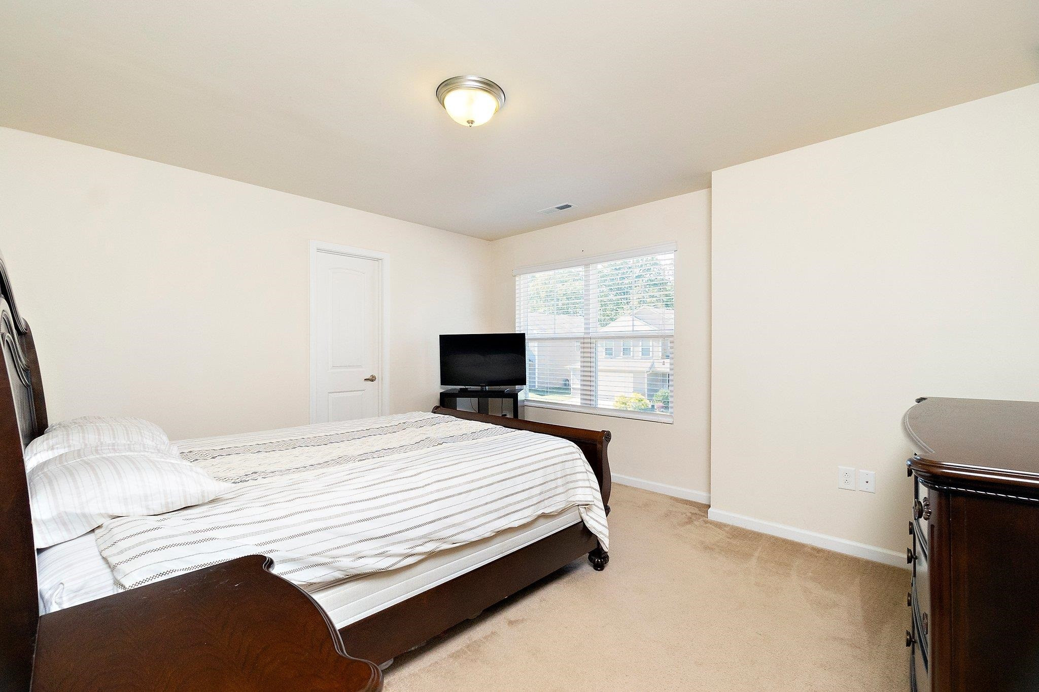 3525 Althorp Drive Raleigh, NC 27616 - Photo 22 of 28 a bedroom with a bed and a window