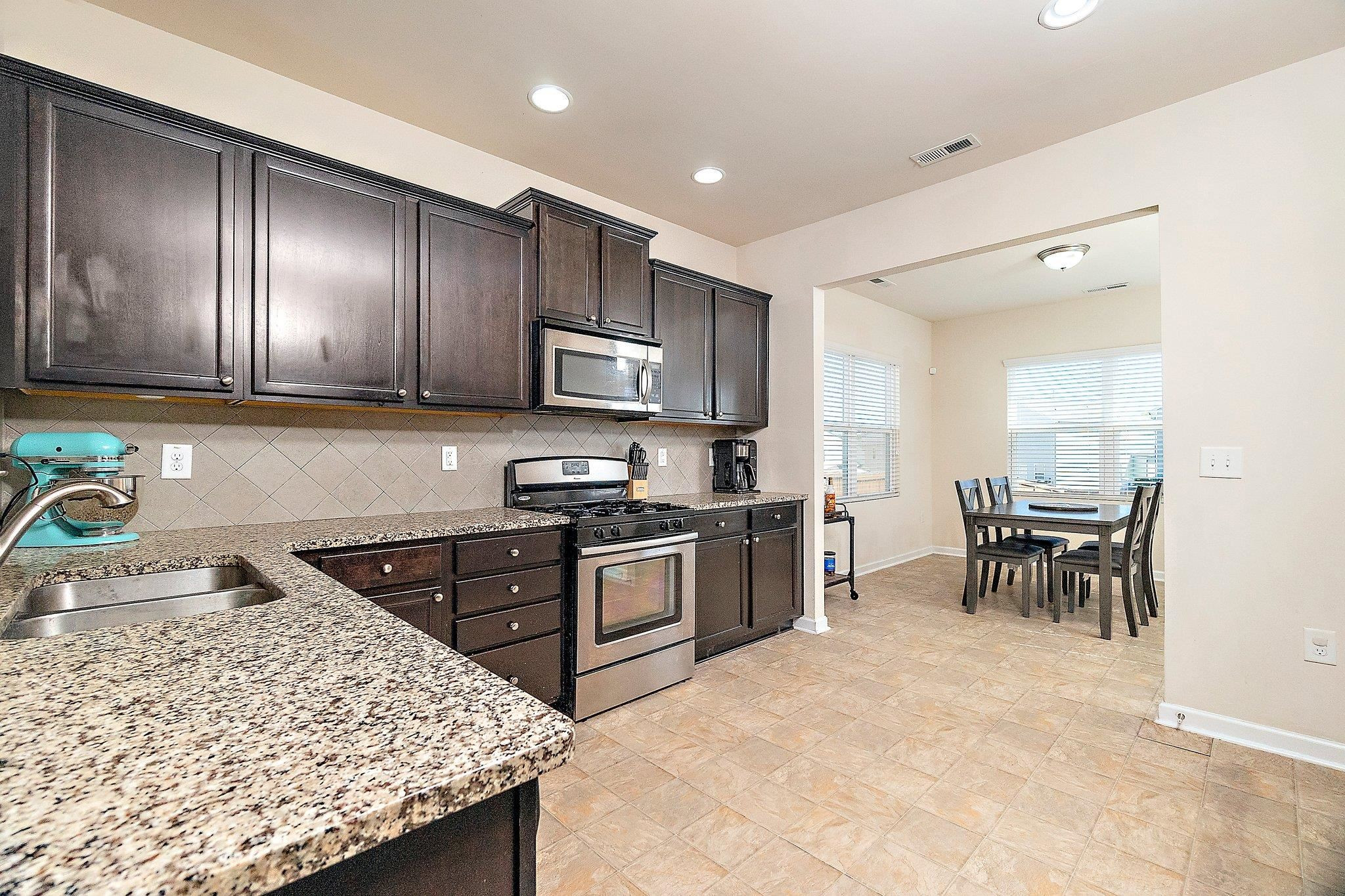 3525 Althorp Drive Raleigh, NC 27616 - Photo 5 of 28 a kitchen with stainless steel appliances granite countertop sink stove refrigerator and cabinets