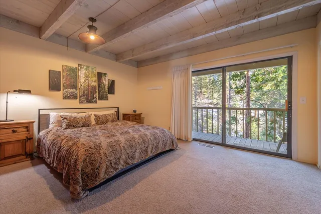 a spacious bedroom with a large bed and a large window
