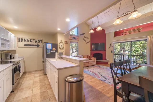 a kitchen that has a lot of cabinets a sink and a stove
