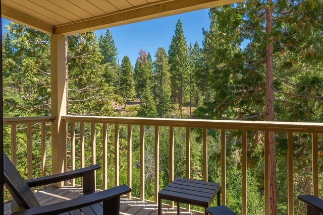 a view of a balcony with wooden floor and outdoor space