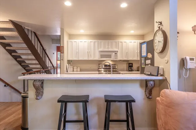 a kitchen with stainless steel appliances a sink and a refrigerator