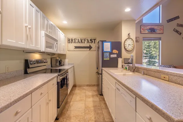 a kitchen with a sink stove and refrigerator