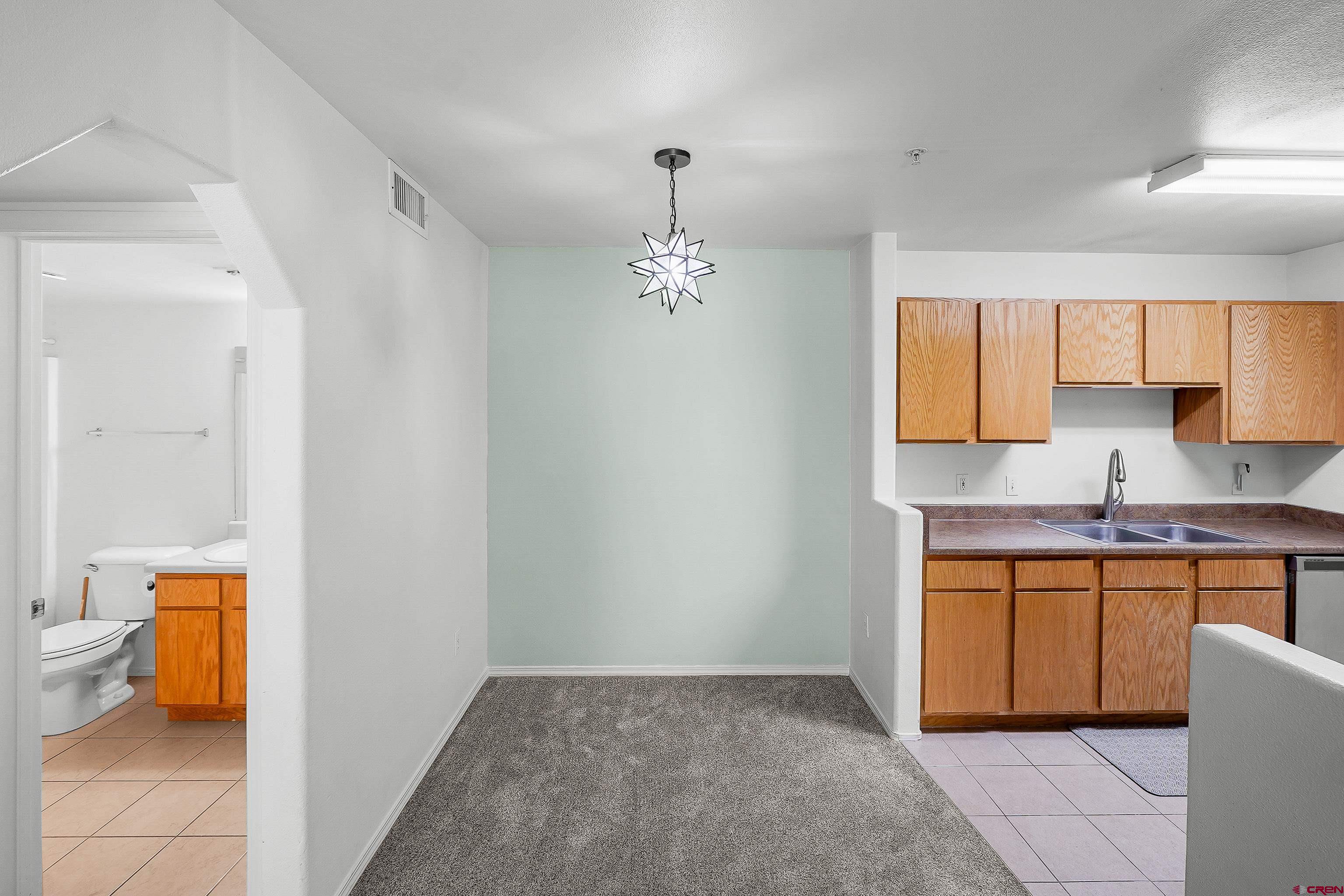 1100 Goeglein Gulch Road, Unit 163 Durango, CO 81301 - Photo 11 of 23 a kitchen with a sink and a window