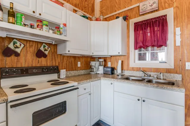 a kitchen with stainless steel appliances granite countertop a sink stove and cabinets