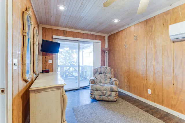 a living room with furniture and large windows