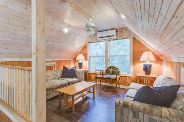 a living room with furniture and a floor to ceiling window