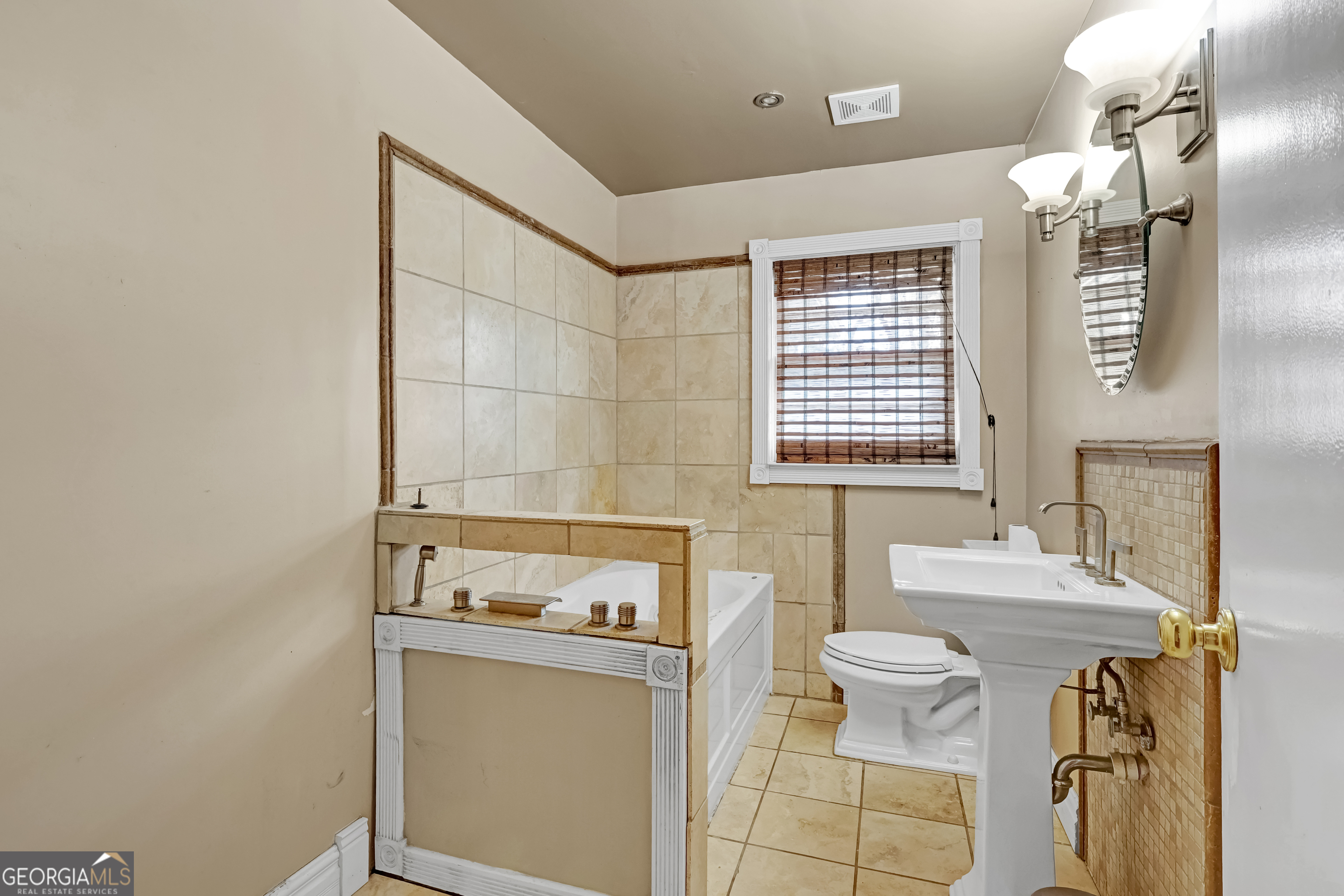 1077 Helen Street Morrow, GA 30260 - Photo 12 of 18 a bathroom with a sink toilet and mirror