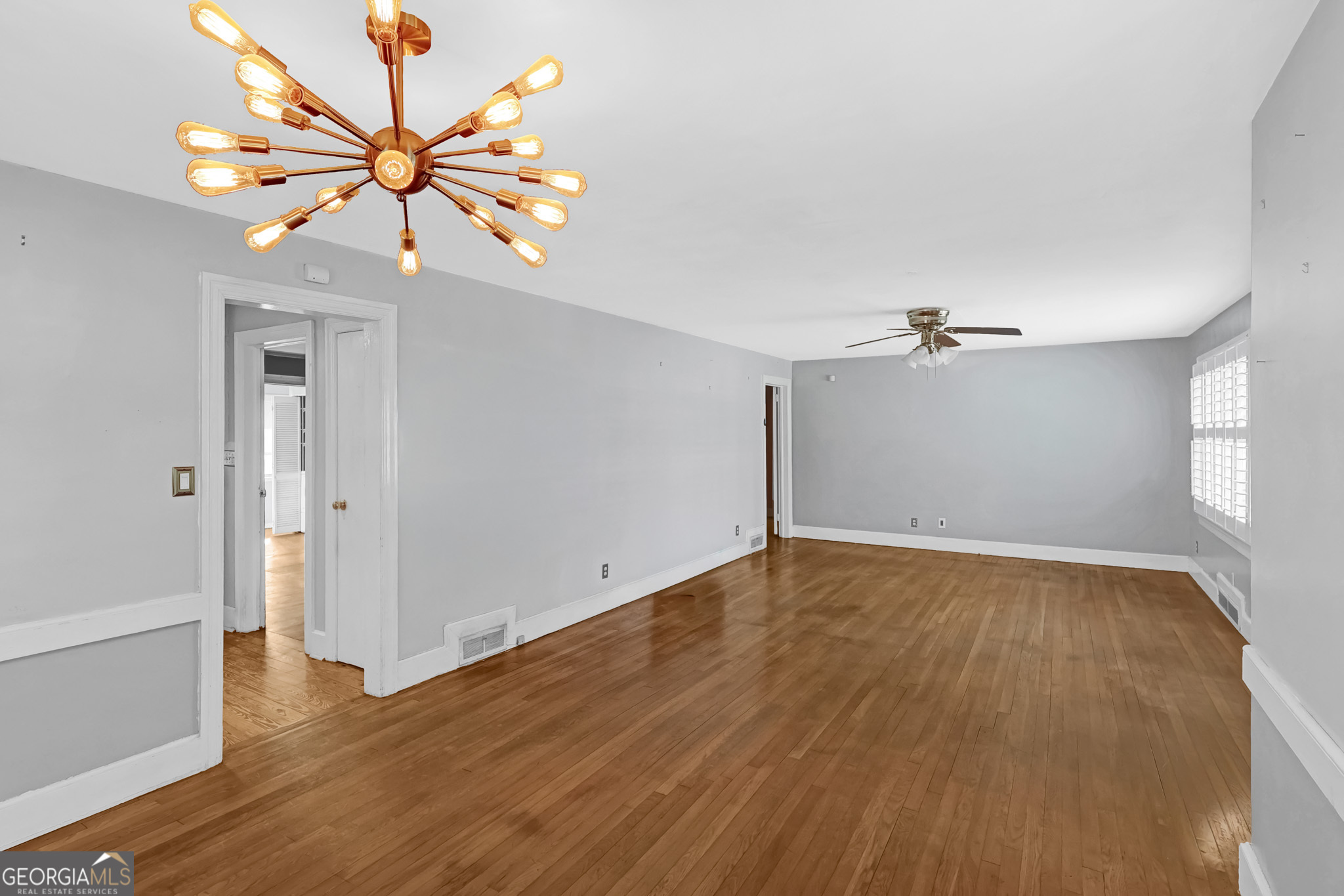 1077 Helen Street Morrow, GA 30260 - Photo 3 of 18 a view of an empty room with wooden floor and a window