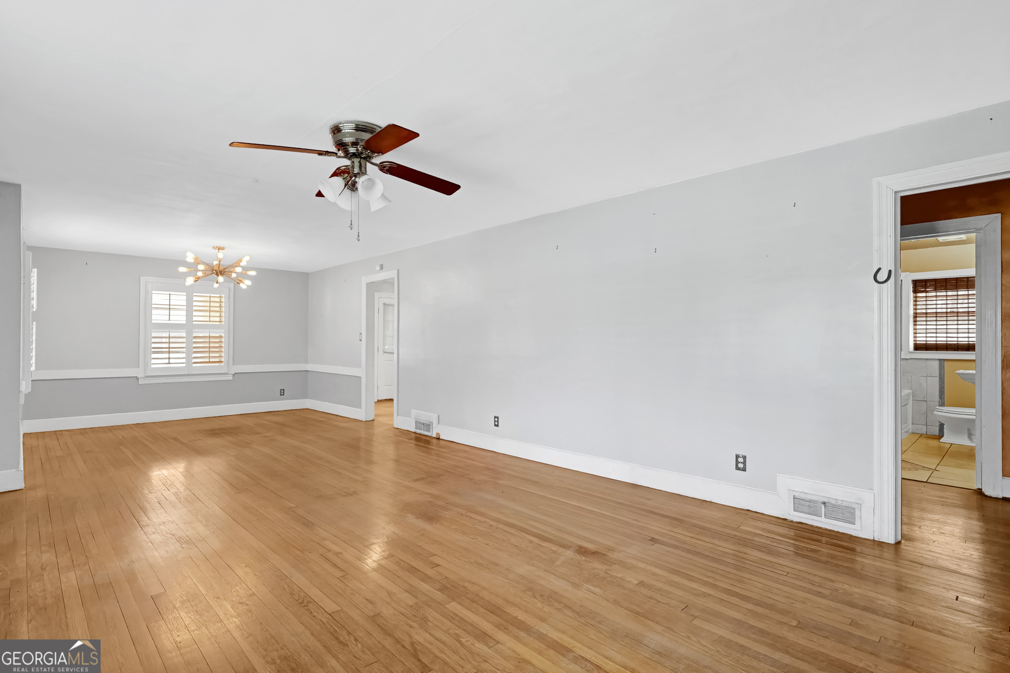 1077 Helen Street Morrow, GA 30260 - Photo 4 of 18 wooden floor in an empty room with a window