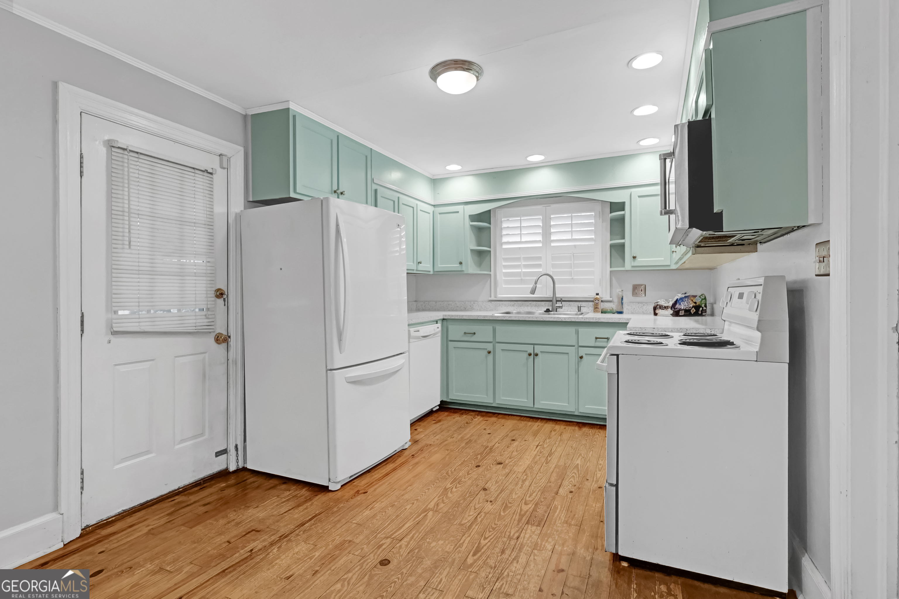 1077 Helen Street Morrow, GA 30260 - Photo 5 of 18 a kitchen with a refrigerator a sink and cabinets