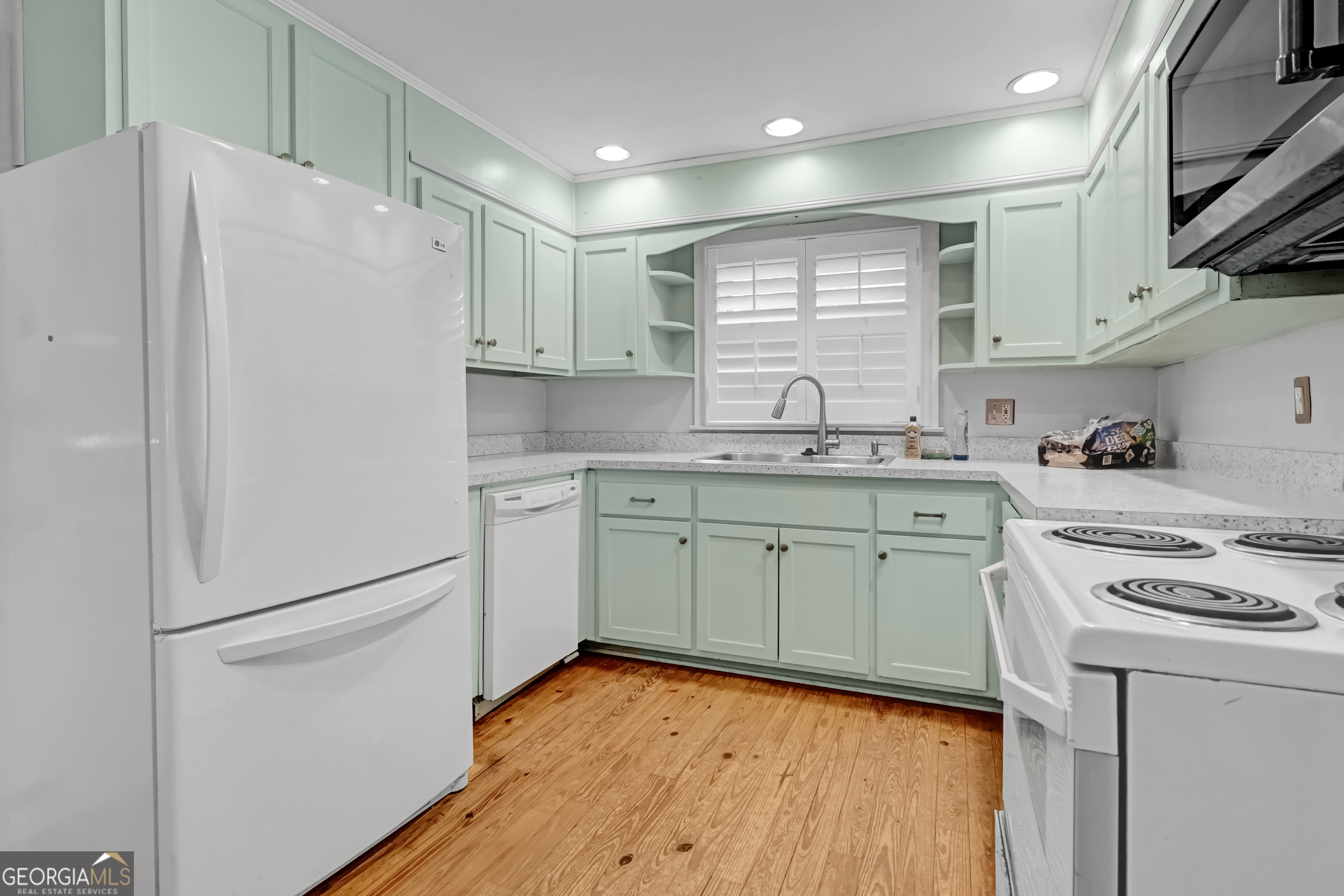 1077 Helen Street Morrow, GA 30260 - Photo 6 of 18 a kitchen with stainless steel appliances a refrigerator sink and cabinets