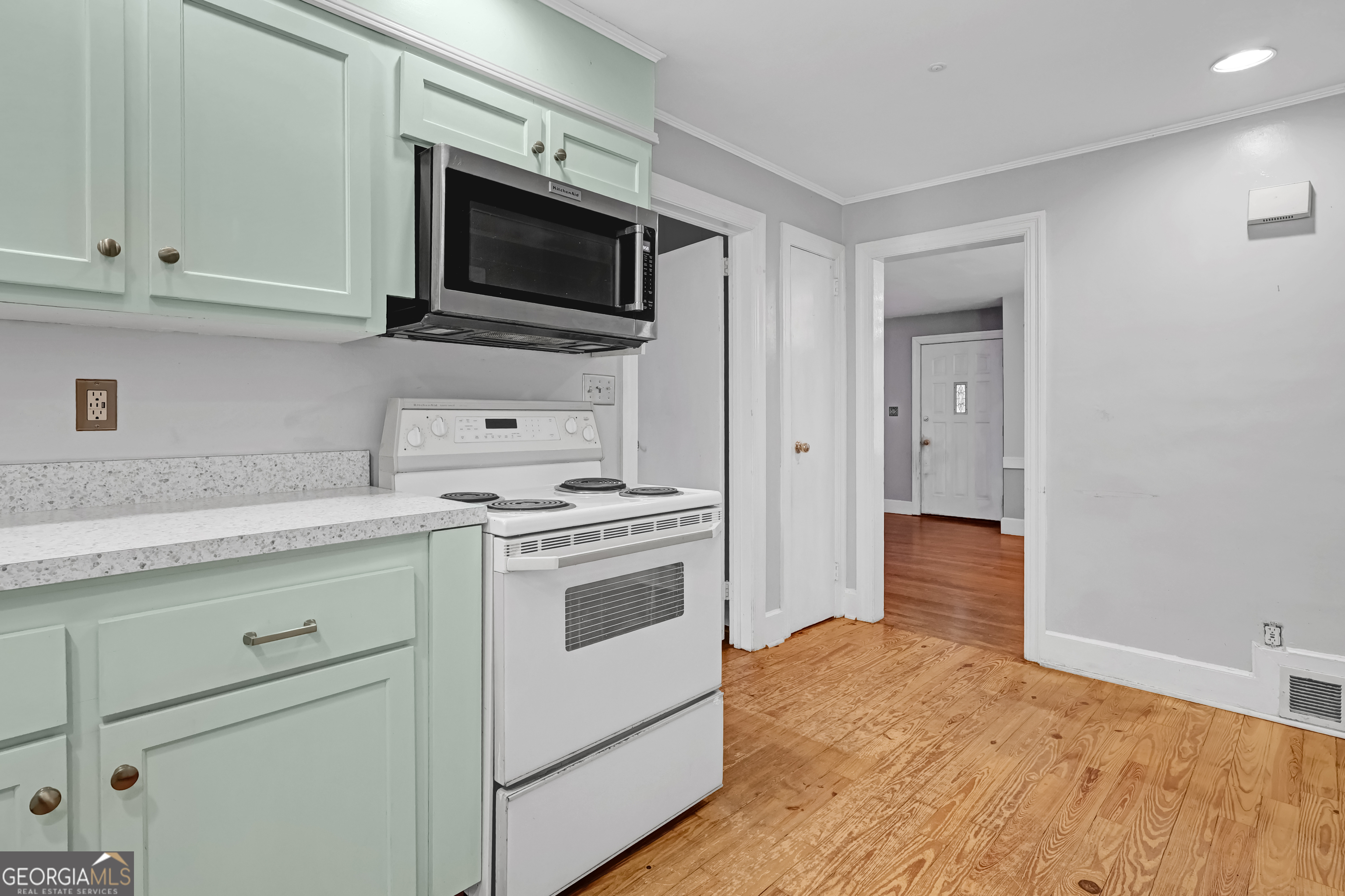 1077 Helen Street Morrow, GA 30260 - Photo 7 of 18 a kitchen with a stove and a microwave