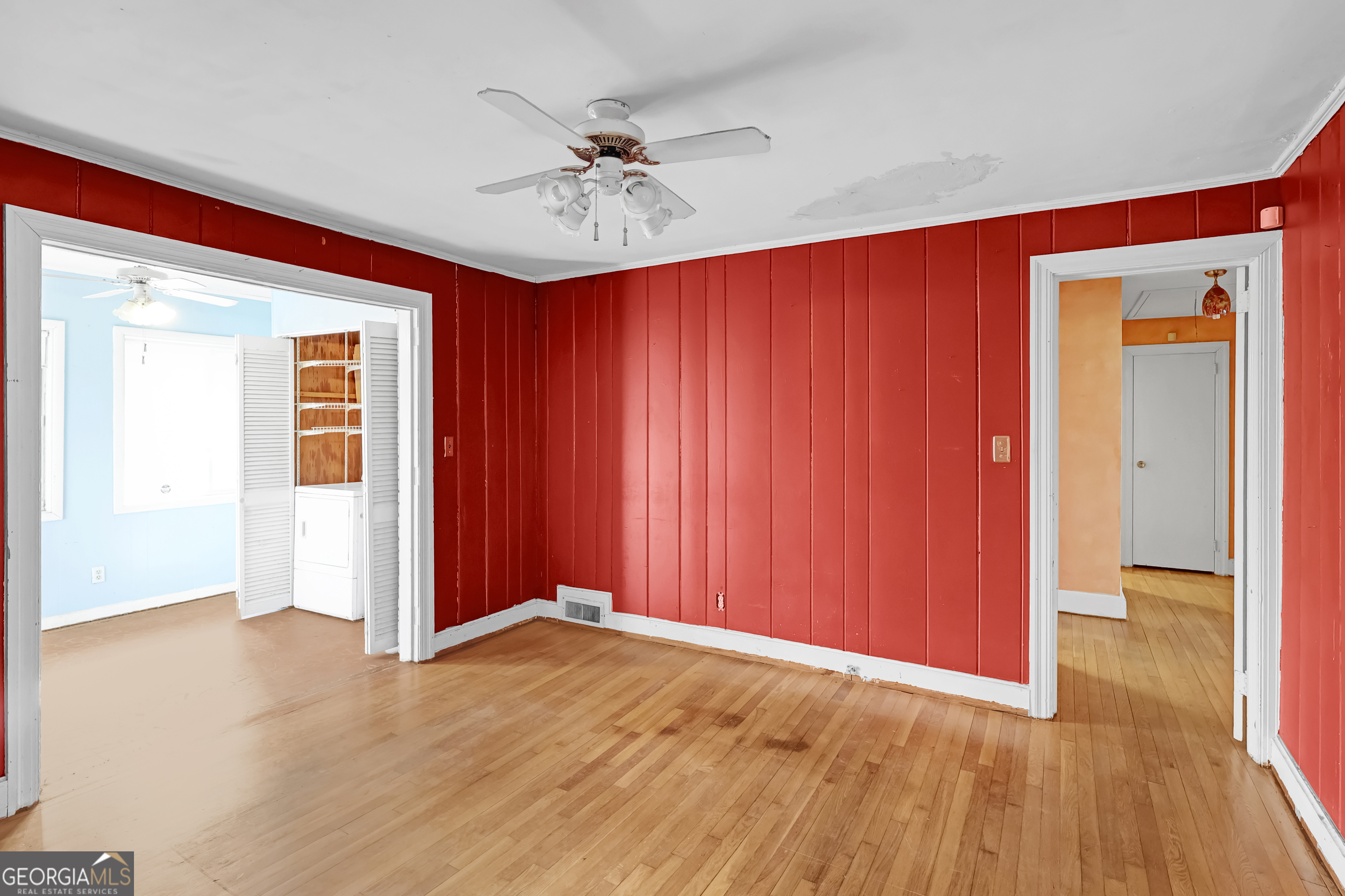 1077 Helen Street Morrow, GA 30260 - Photo 10 of 18 an empty room with wooden floor closet and chandelier fan