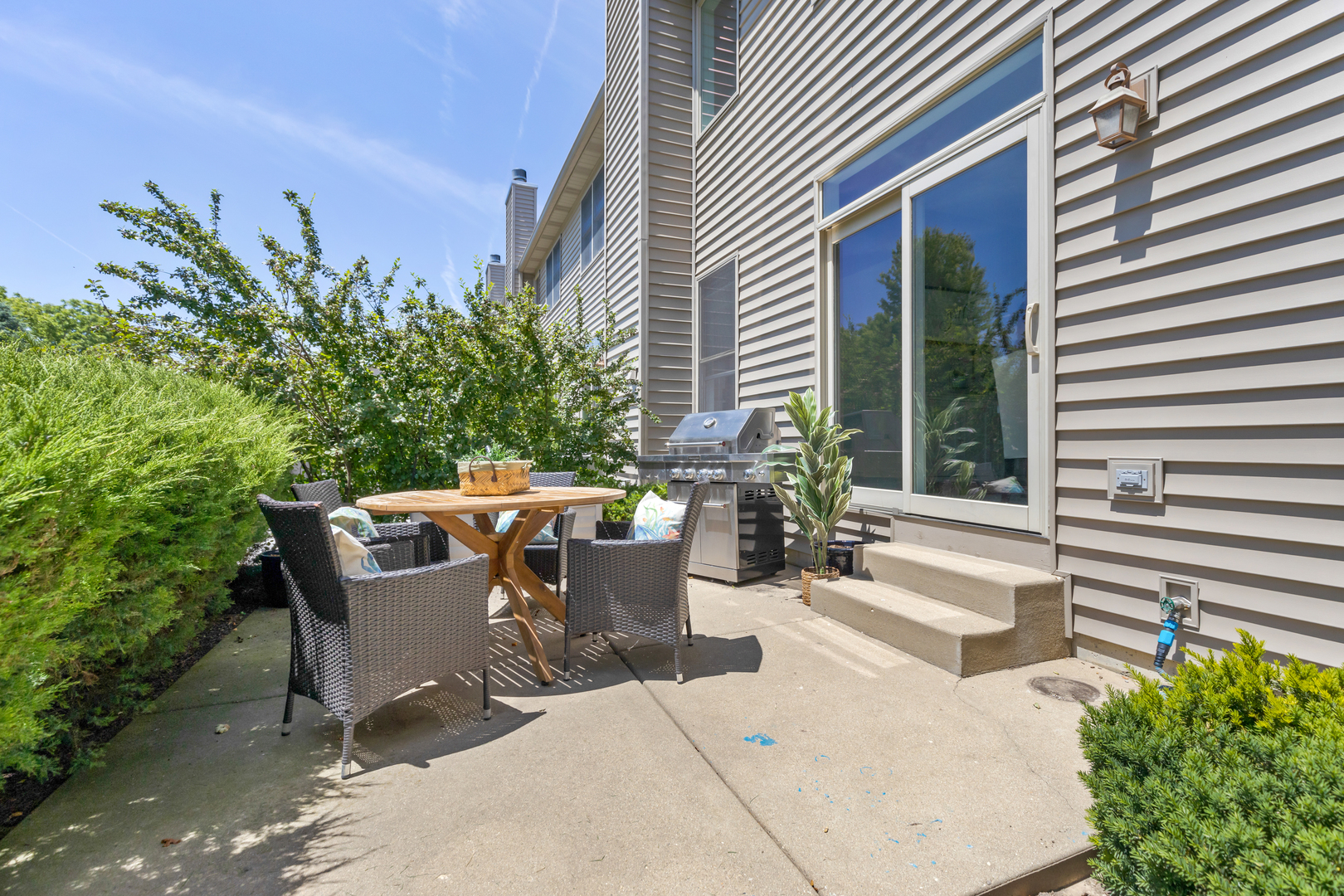 1016 Inverness Drive Antioch, IL 60002 - Photo 23 of 24 a view of a patio with table and chairs and potted plants