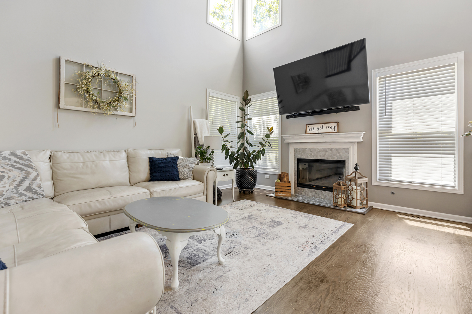 1016 Inverness Drive Antioch, IL 60002 - Photo 8 of 24 a living room with furniture a fireplace and a flat screen tv