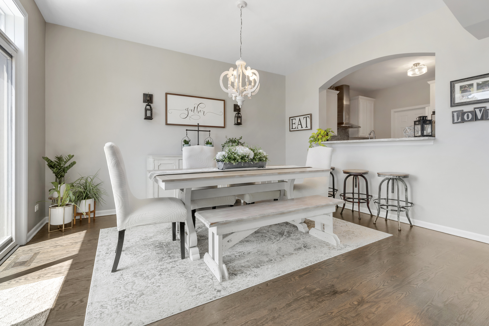 1016 Inverness Drive Antioch, IL 60002 - Photo 9 of 24 a dining room with wooden floor a chandelier a wooden table and chairs