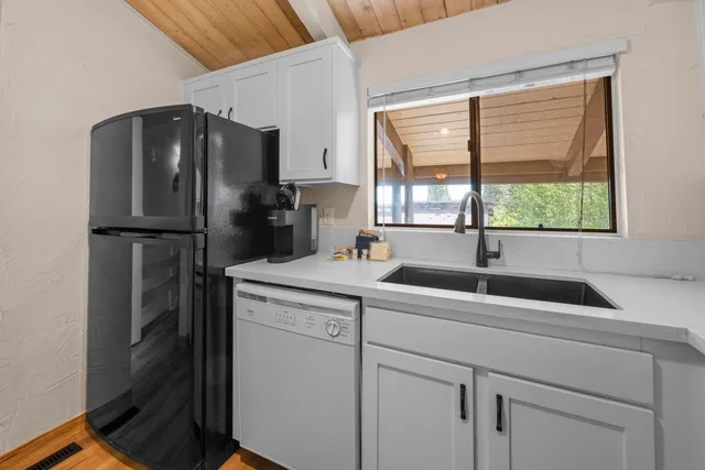 a kitchen with a sink a refrigerator and window